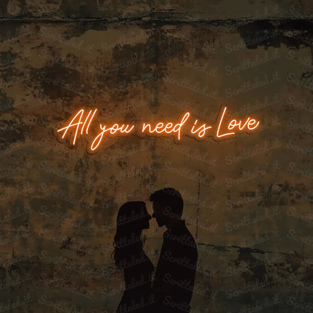 scritta neon all you need is love colore arancione