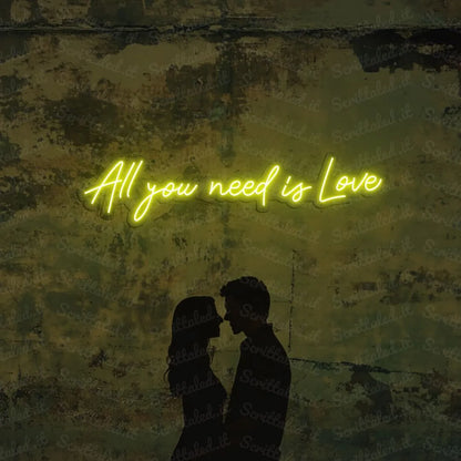 scritta neon all you need is love colore giallo