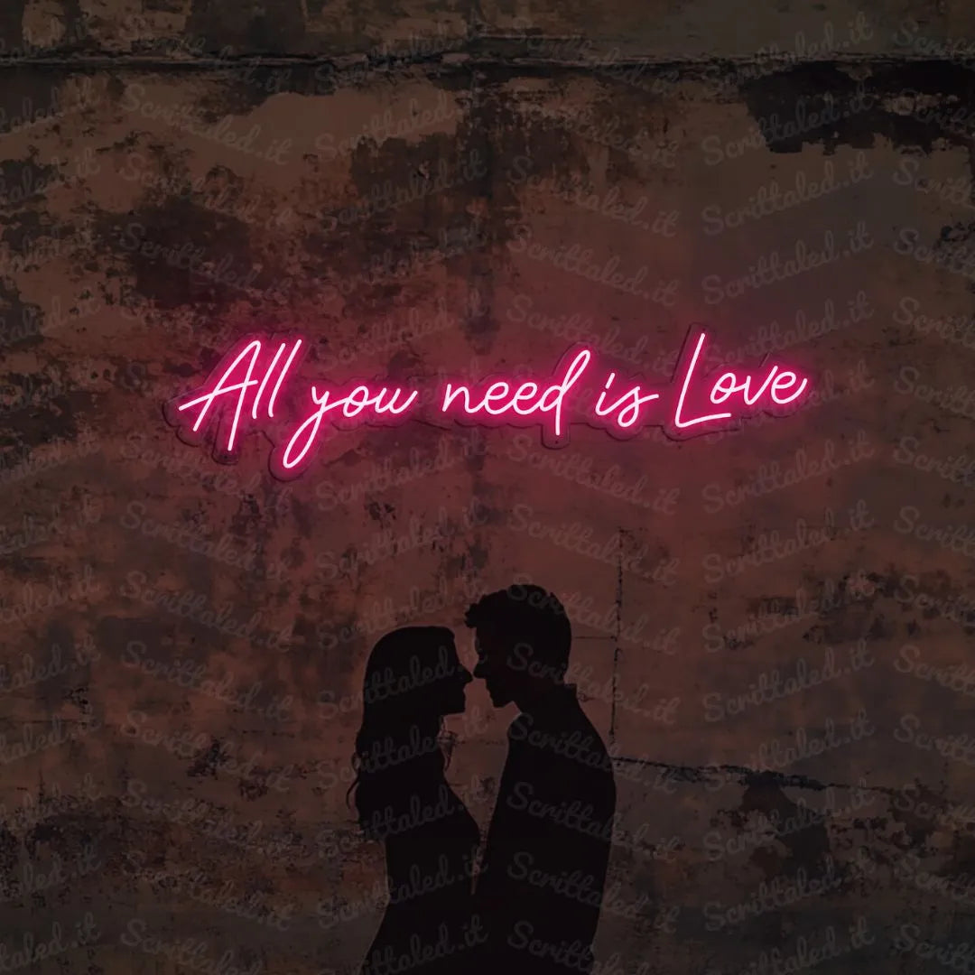 scritta neon all you need is love colore rosa