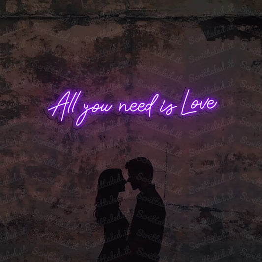 scritta neon all you need is love colore viola